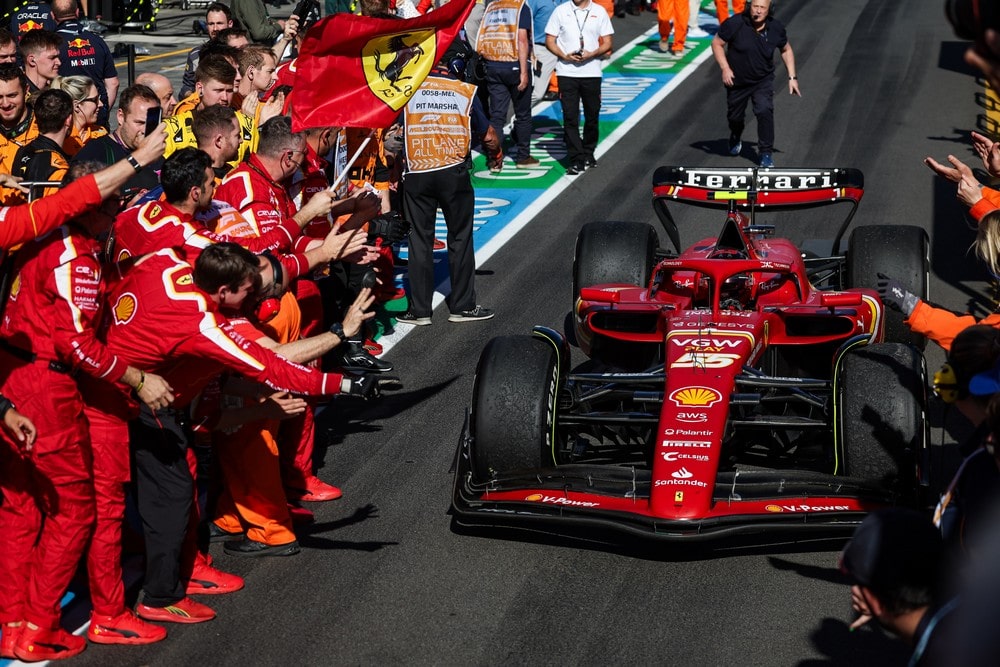Carlos Sainz driving alongside Ferrari mechanics after winning the 2024 Australian Grand Prix