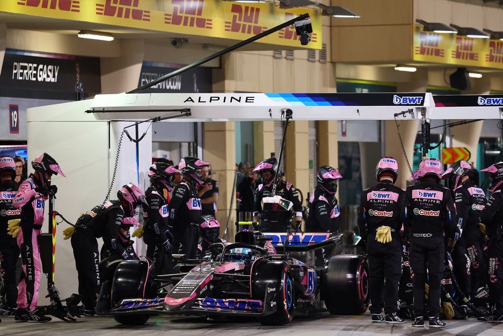 Alpine team members gathered around the car of Pierre Gasly in the pit lane during the 2024 Bahrain Grand Prix