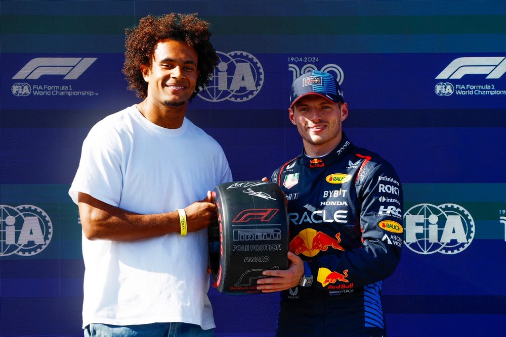 Bologna FC football player Joshua Zirkzee (left) presents the Pirelli Pole Position Award to Max Verstappen (right) after qualifying for the 2024 Emilia Romagna Grand Prix