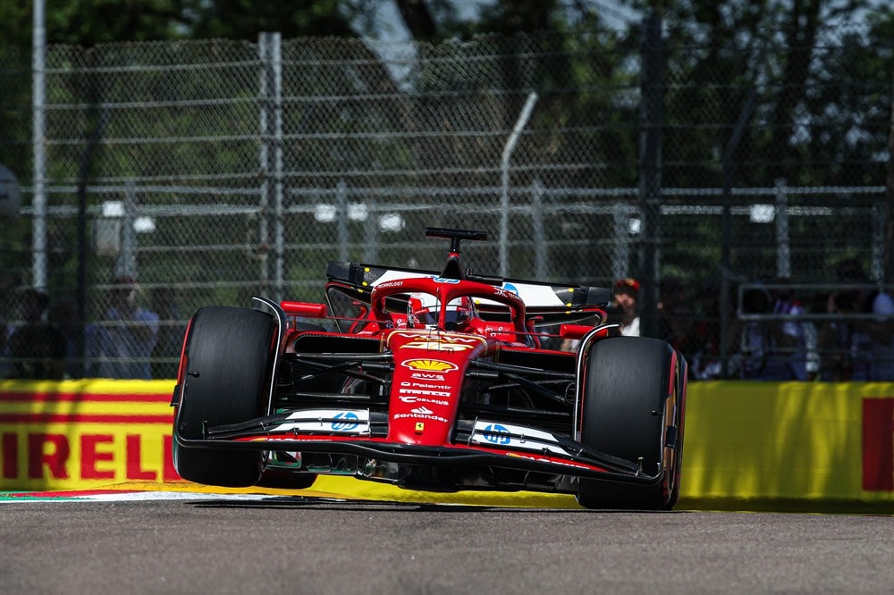 Charles Leclerc racing over a kerb at the 2024 Imola Grand Prix