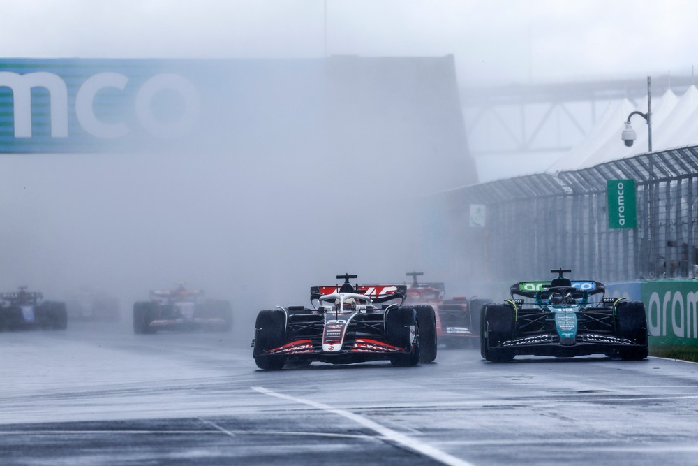 Kevin Magnussen (left) overtakes Lance Stroll (right) in wet conditions at the start of the 2024 Canadian Grand Prix