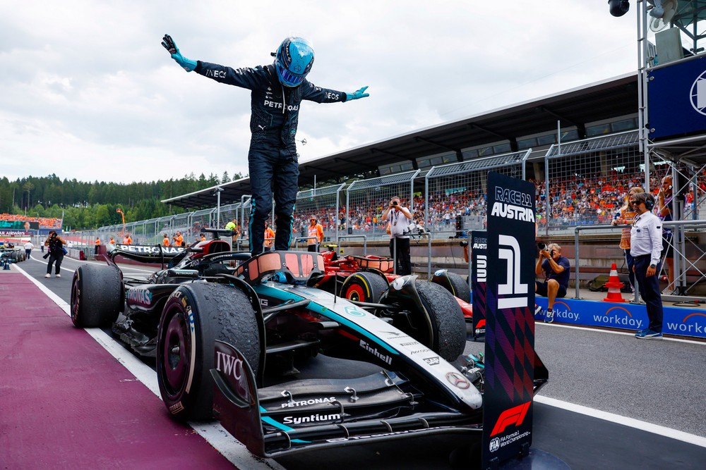 George Russell celebrating atop his Mercedes Formula One car after winning the 2024 Austrian Grand Prix