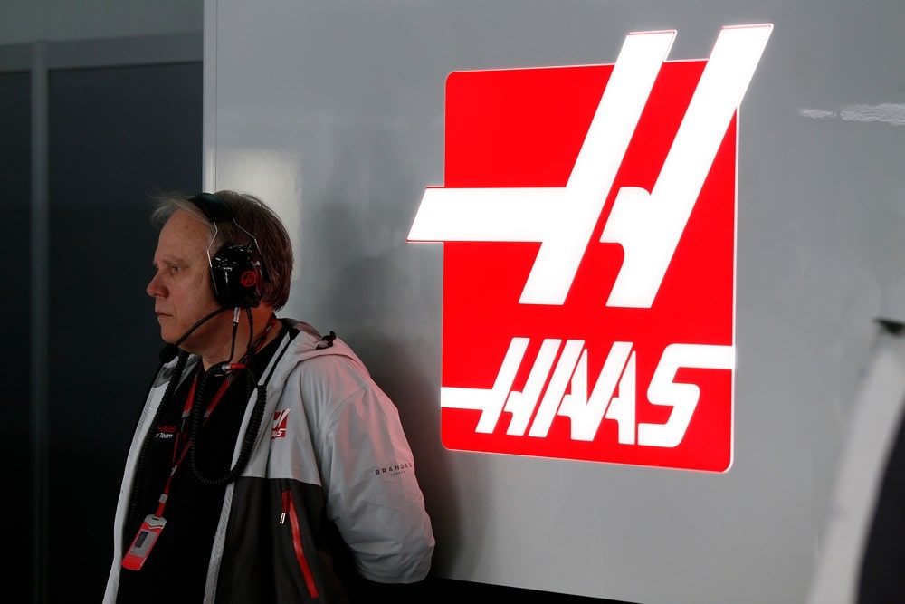 Gene Haas standing in front of a Haas logo