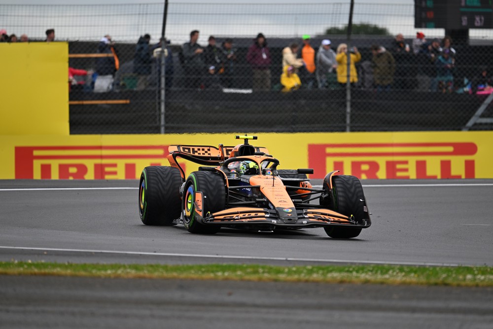 Lando Norris racing in damp conditions during 2024 British Grand Prix practice