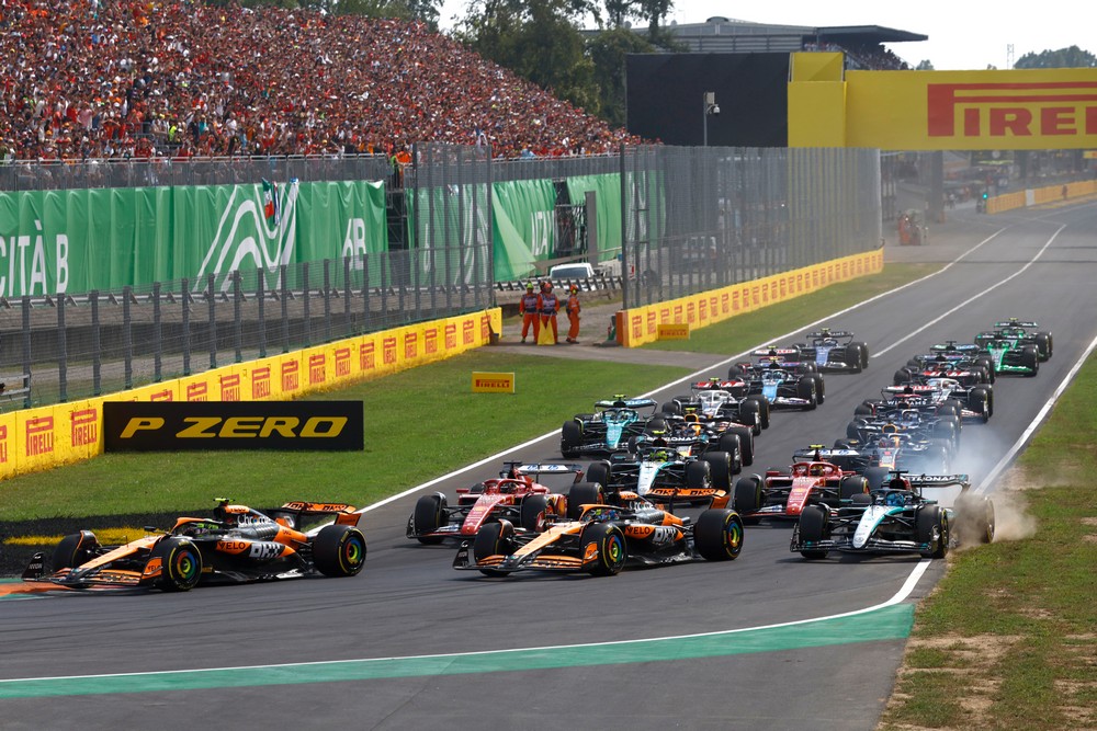 George Russell dips a wheel on the grass in the first corner of the 2024 Italian Grand Prix