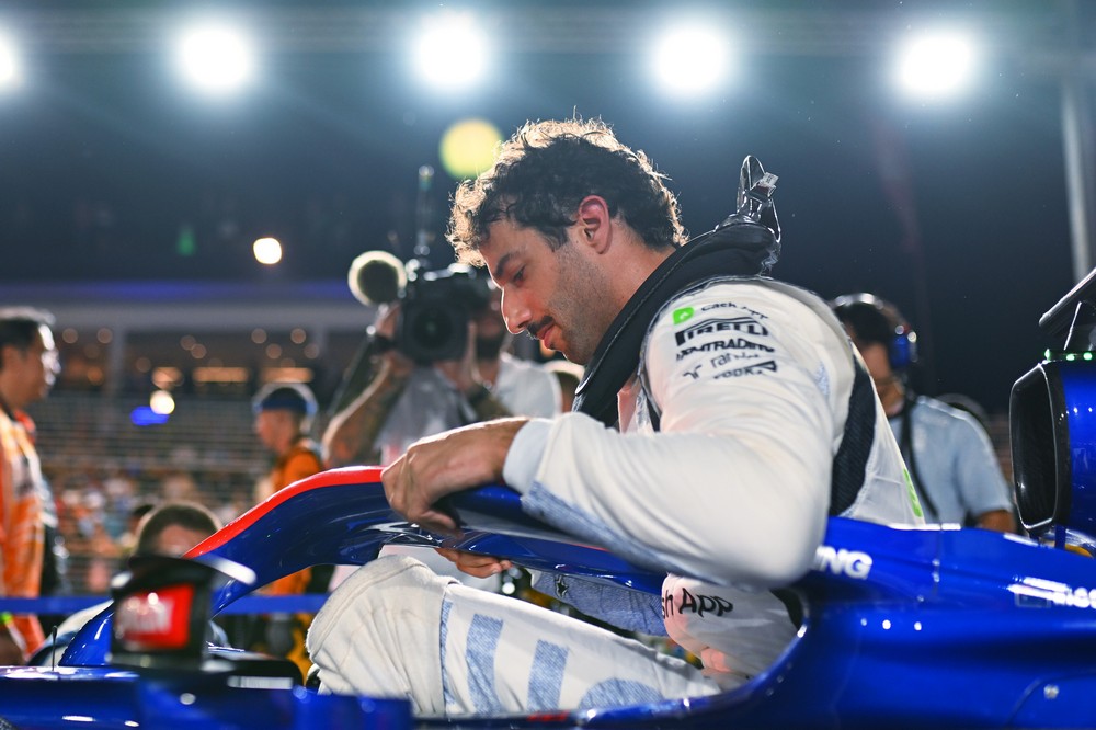 Daniel Ricciardo climbing into the cockpit of his RB for the final time ahead of the 2024 Singapore Grand Prix