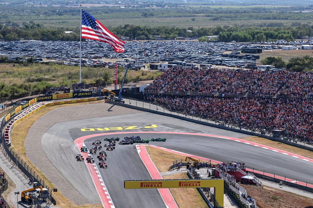 Aerial view of drivers racing into the first corner at the start of the 2024 United States Grand Prix