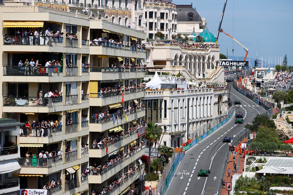 Fans crowd the balconies of a Monaco apartment to watch cars race on the streets below