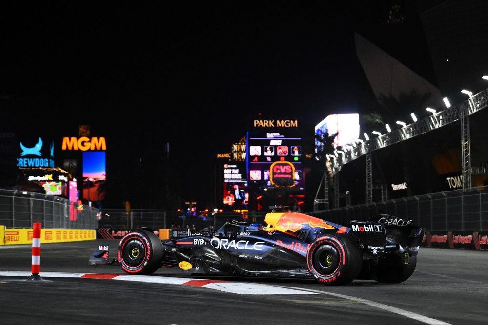 Max Verstappen racing in the 2024 Las Vegas Grand Prix with the Las Vegas cityscape in the background