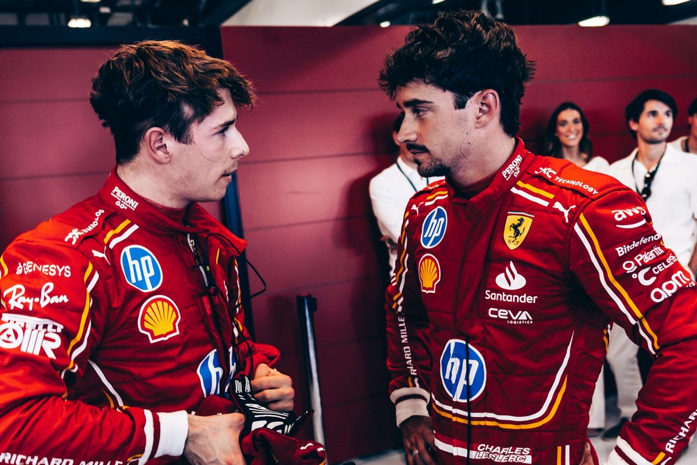 Brothers Arthur (left) and Charles Leclerc (right) talk in the Ferrari garage during practice for the 2024 Abu Dhabi Grand Prix