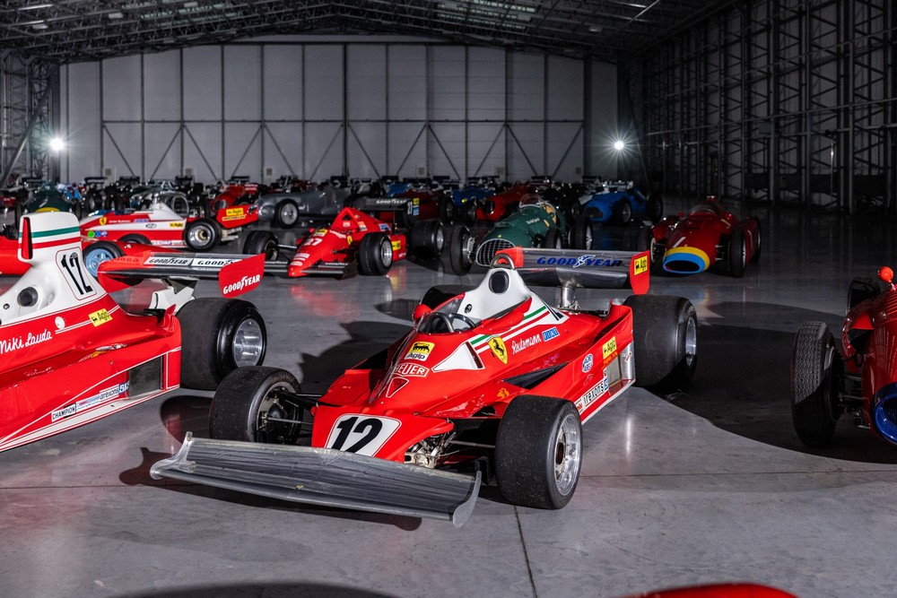 A Ferrari 312T2 with many cars from Bernie Ecclestone's collection in the background