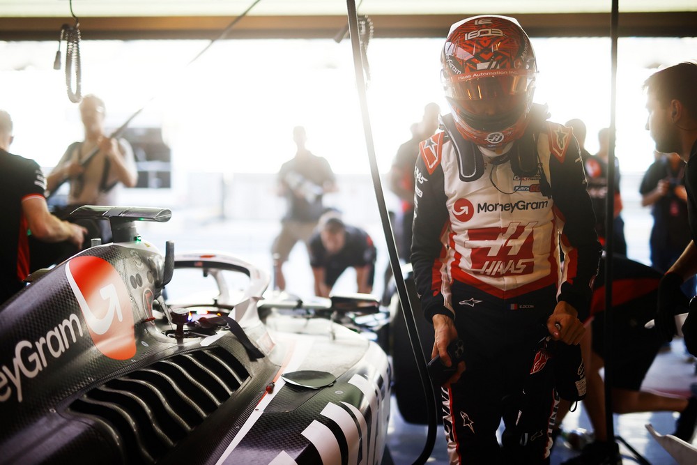 Esteban Ocon standing beside his Haas car during the 2024 Abu Dhabi post-season test