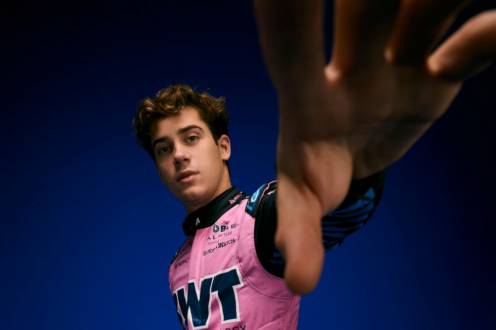 Franco Colapinto reaches for the camera in a 2025 pre-season photoshoot with Alpine