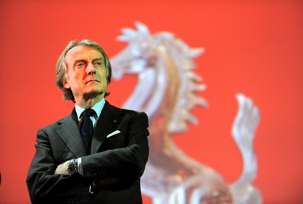 Italian businessman Luca di Montezemolo standing in front of a Ferrari prancing horse