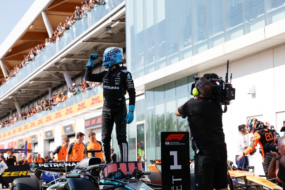George Russell celebrates while standing on his car after winning pole position for the 2025 Canadian Grand Prix