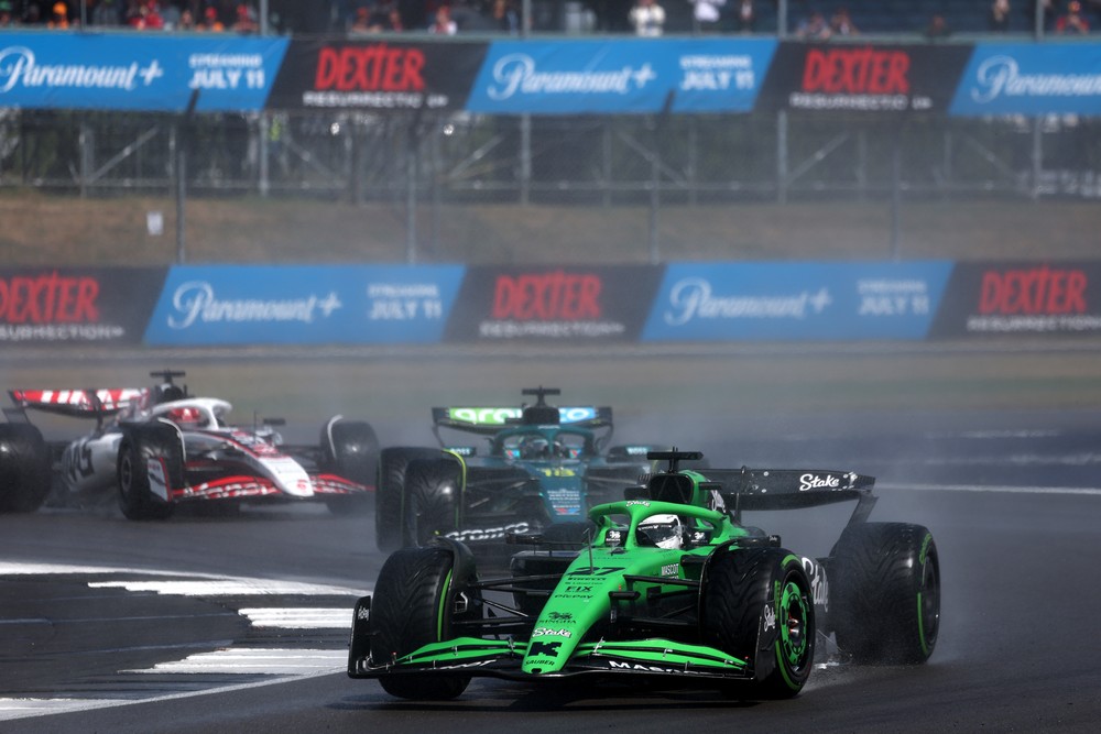 Nico Hulkenberg leads Lance Stroll in wet conditions during the 2025 British Grand Prix