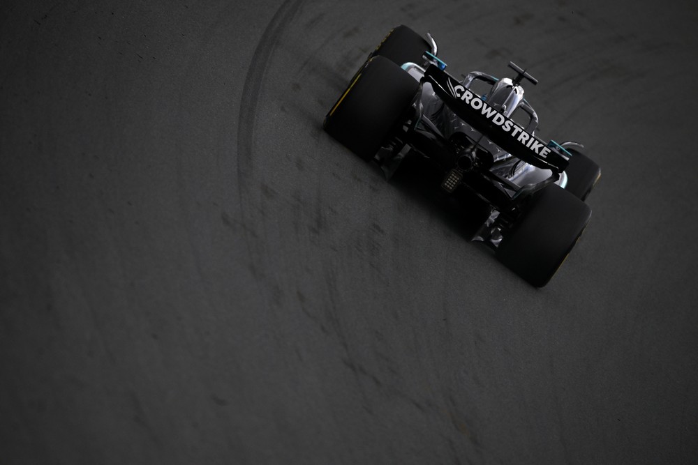 Rear of George Russell's Mercedes as he rounds a banked corner during practice for the 2025 Dutch Grand Prix