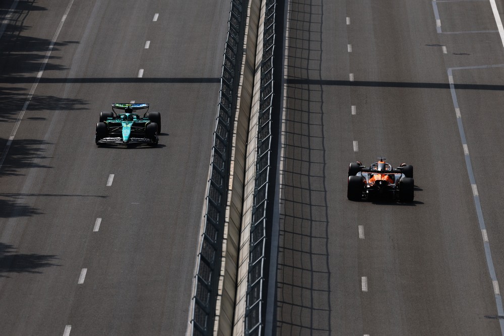 Fernando Alonso and Oscar Piastri pass each other on opposite ends of the circuit during practice for the 2025 Azerbaijan Grand Prix