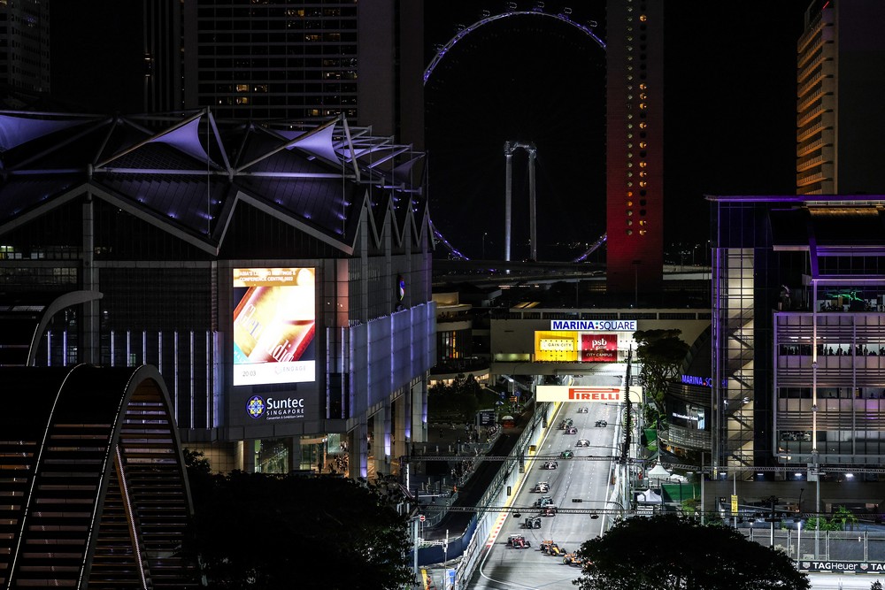 Cars race through the city streets on the opening lap of the 2025 Singapore Grand Prix