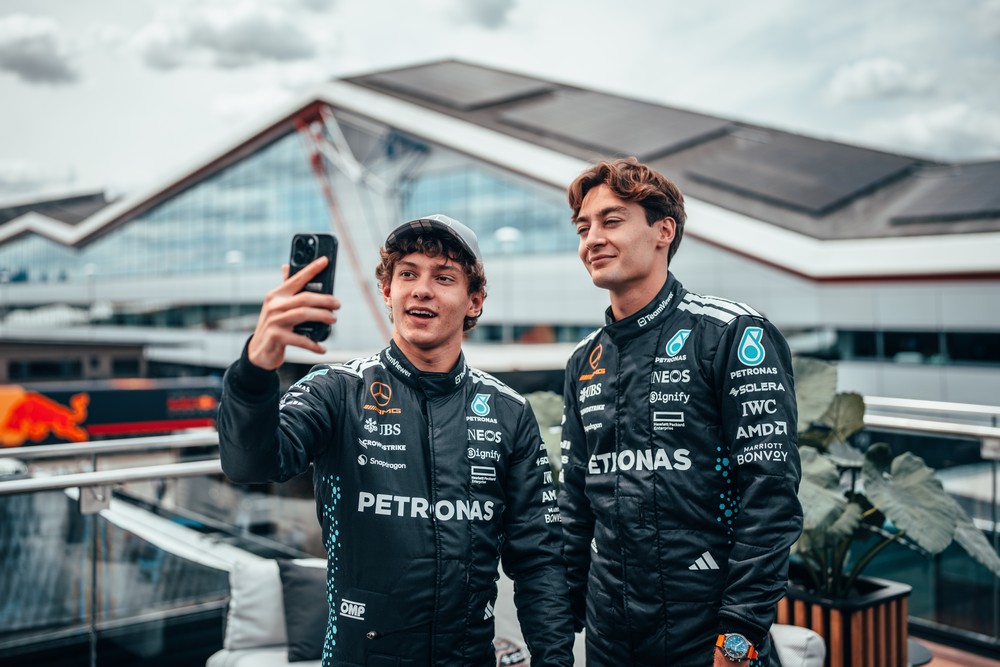 Kimi Antonelli (left) and George Russell (right) take a selfie during the 2025 British Grand Prix weekend