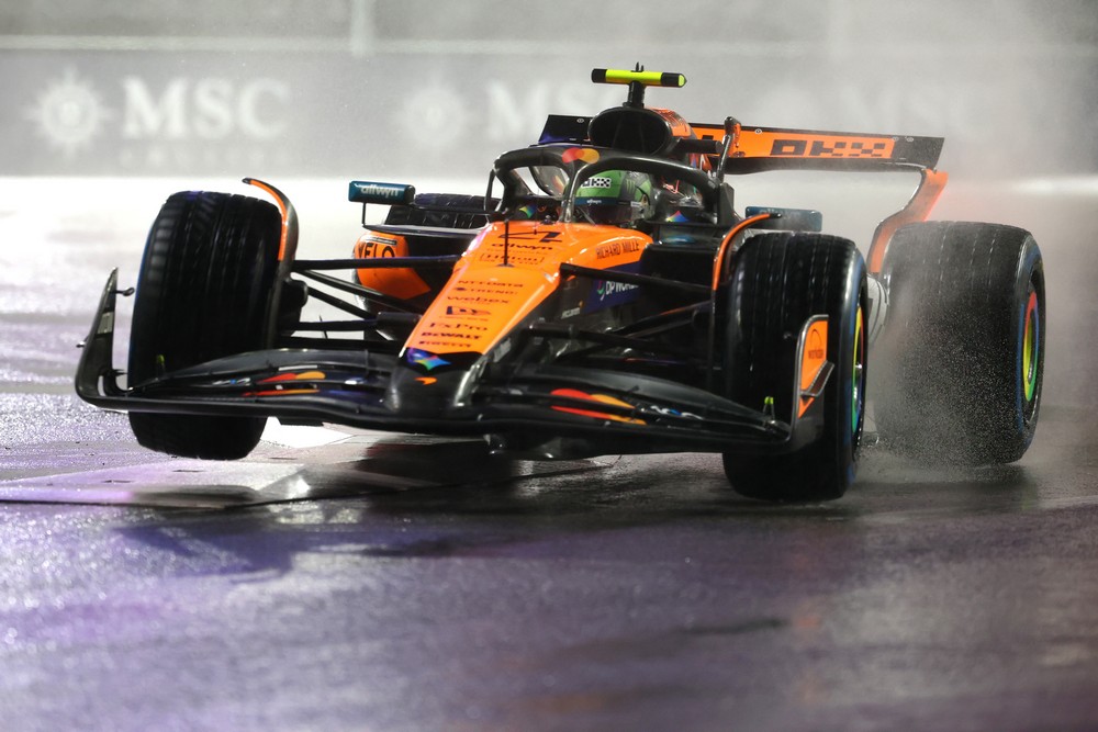 Lando Norris bounces over the kerbs in the wet while qualifying for the 2025 Las Vegas Grand Prix