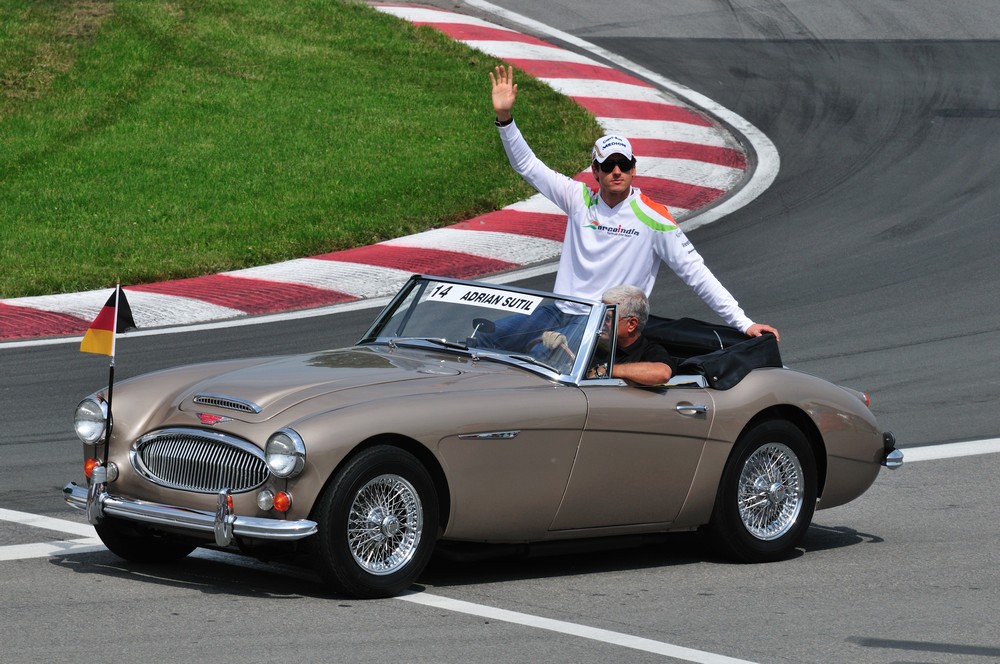 Adrian Sutil rides in an Austin Healey during the driver parade at the 2010 Canadian Grand Prix