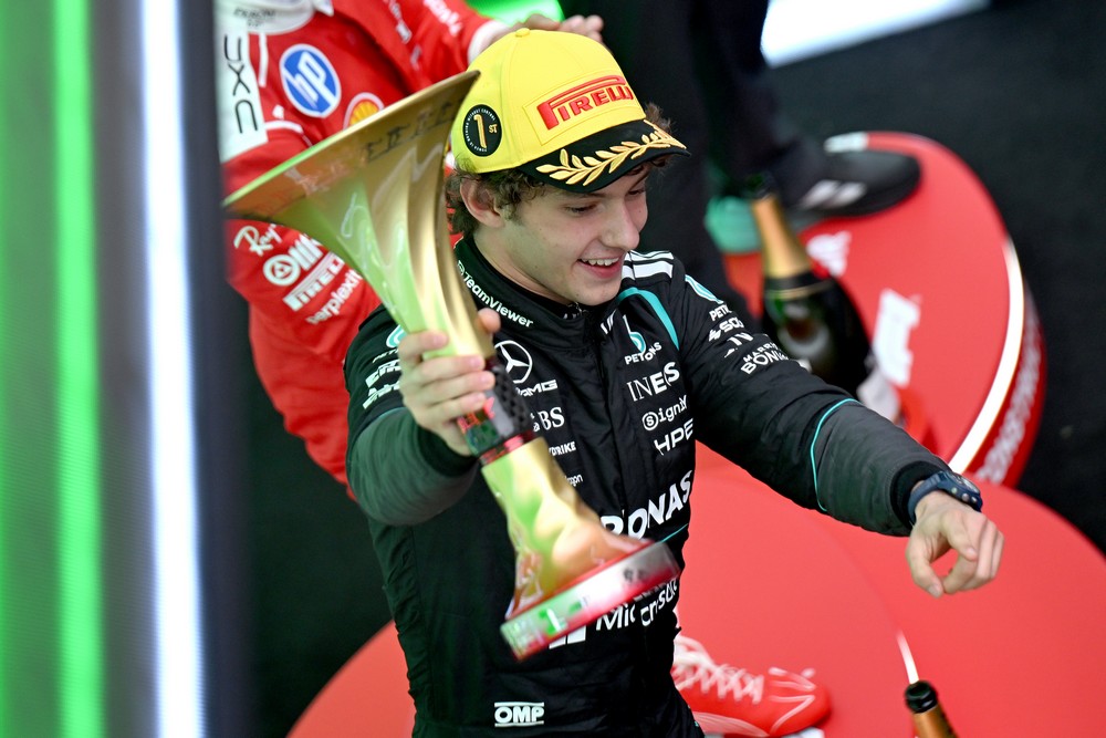 Kimi Antonelli holds his trophy on the podium after winning the 2026 Chinese Grand Prix